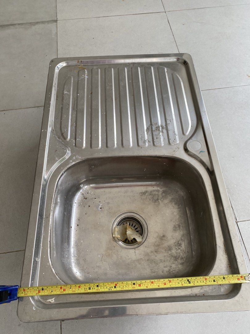 Stainless Steel Kitchen Sink with Drainer (Category: Bathroom & Kitchen Fixtures) located in Quezon City. Submitted by gab_tan (Listing ID 1457600885, Image 2). Description: - Single bowl stainless steel kitchen sink - Includes drainer on the right side - Approximate measurements: 80cm x 45cm - Ideal for kitchen renovations or replacements.