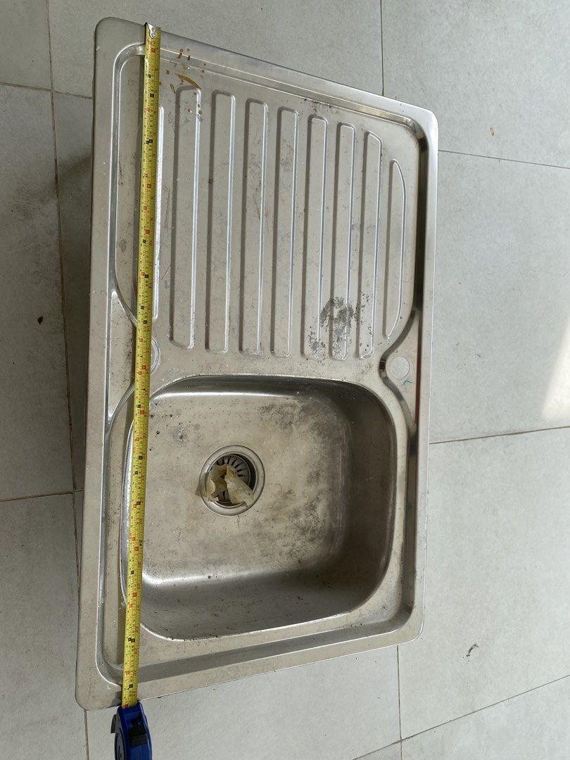 Stainless Steel Kitchen Sink with Drainer (Category: Bathroom & Kitchen Fixtures) located in Quezon City. Submitted by gab_tan (Listing ID 1457600885, Image 1). Description: - Single bowl stainless steel kitchen sink - Includes drainer on the right side - Approximate measurements: 80cm x 45cm - Ideal for kitchen renovations or replacements.