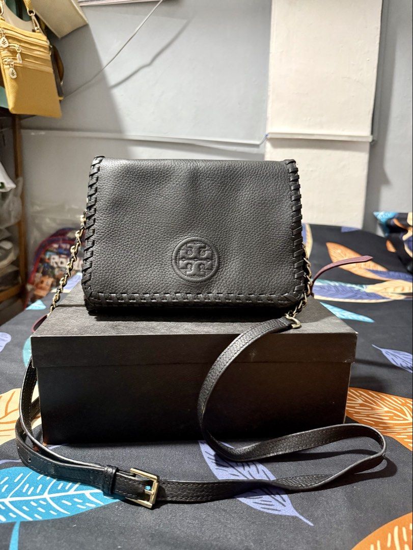 Tory Burch Black Leather Chain Shoulder Bag (Category: Luxury Bags & Wallets) located in Manila. Submitted by bags.shopp (Listing ID 1457661352, Image 2). Description: - Authentic Tory Burch black leather bag - Elegant gold chain strap - Signature embossed logo on the front - Multiple interior compartments for organization - Interior zip pockets for secure storage - Unique and stylish stitching detail - Versatile for everyday use or evening event