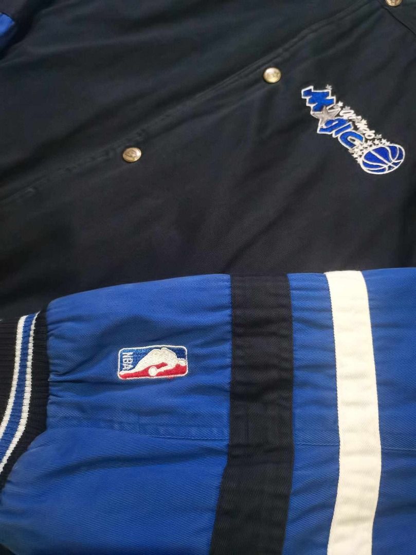 Vintage Reversible Orlando Magic NBA Satin Bomber Jacket (Category: Coats, Jackets and Outerwear) located in Taytay. Submitted by markcasol45 (Listing ID 1457634975, Image 3). Description: - Vintage Orlando Magic jacket - Features embroidered team logo on front and back - Classic blue and black colorway - Striped cuffs and collar for added style - Made by Unishine - Size Large (L) - Perfect for any Orlando Magic fan!.