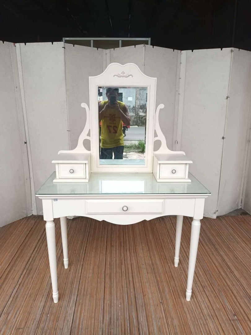 White Dressing Table with Mirror and Drawers (Category: Tables & Sets) located in Antipolo. Submitted by roselle001 (Listing ID 1457652604, Image 1). Description: - Elegant white dressing table - Features a clear glass tabletop - Includes 3 drawers for storage: 2 small top drawers and 1 large front drawer - Drawers lined with charming floral print - Stylish tapered legs - Ideal for organizing your makeup and accessories.