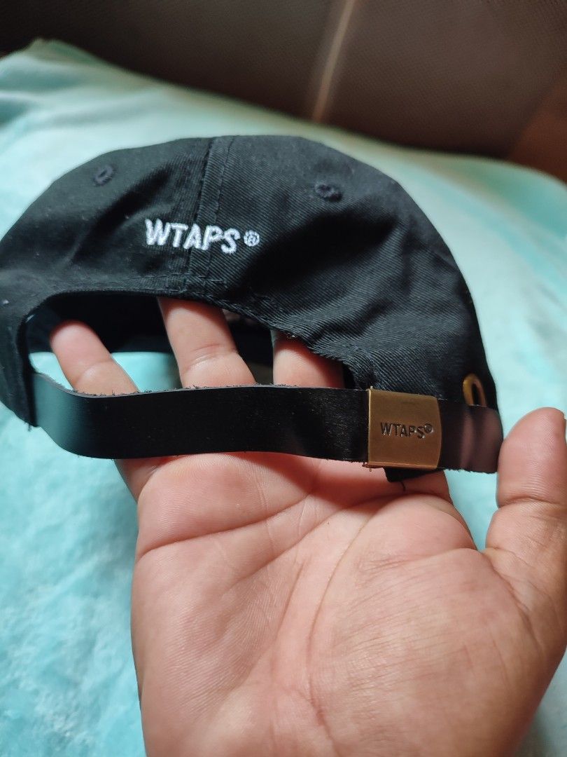 WTAPS Cap Black Cotton Adjustable Strap (Category: Caps & Hats) located in Puerto Princesa. Submitted by thriftedsoulsy2k (Listing ID 1457628032, Image 2). Description: - Black WTAPS cap - Made from durable cotton - Features embroidered WTAPS logo on front and back - Adjustable strap with metal buckle for a custom fit - Size X00 - Ideal for everyday wear.
