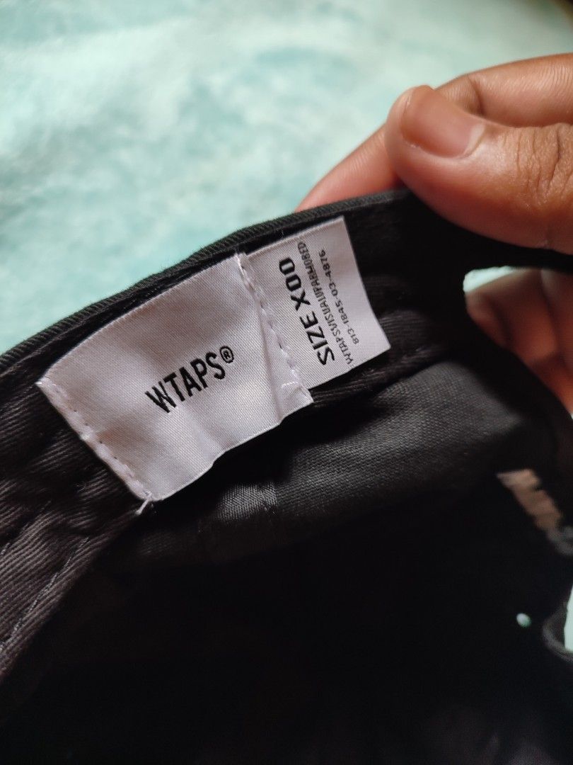 WTAPS Cap Black Cotton Adjustable Strap (Category: Caps & Hats) located in Puerto Princesa. Submitted by thriftedsoulsy2k (Listing ID 1457628032, Image 3). Description: - Black WTAPS cap - Made from durable cotton - Features embroidered WTAPS logo on front and back - Adjustable strap with metal buckle for a custom fit - Size X00 - Ideal for everyday wear.