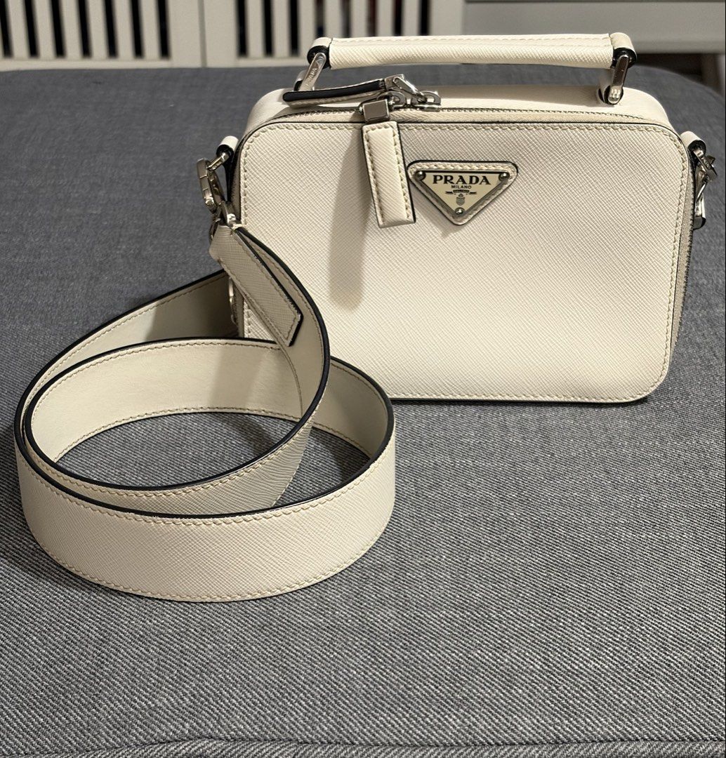 2021 Prada Brique Off-White (Category: Luxury Bags & Wallets) located in Quezon City. Submitted by thebespoketraveler (Listing ID 1457830576, Image 2). Description: 2021 Prada Brique (Small) Off-White w/ adjustable Saffiano Leather Strap Currently Discontinued 100k - White Saffiano Leather, Complete With Dust Bag, Authenticity Card, Tags, Receipt from Isetan Japan - No Box, Left it in the hotel - Bag is in excellent condition (must see to appreci