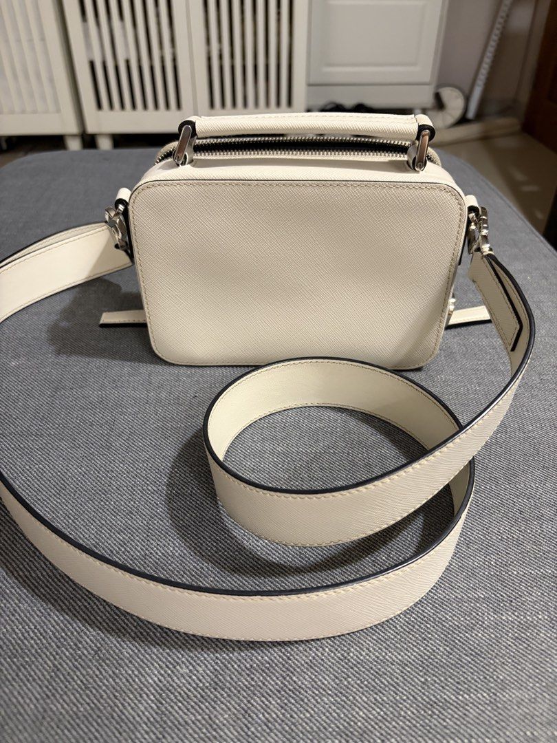 2021 Prada Brique Off-White (Category: Luxury Bags & Wallets) located in Quezon City. Submitted by thebespoketraveler (Listing ID 1457830576, Image 3). Description: 2021 Prada Brique (Small) Off-White w/ adjustable Saffiano Leather Strap Currently Discontinued 100k - White Saffiano Leather, Complete With Dust Bag, Authenticity Card, Tags, Receipt from Isetan Japan - No Box, Left it in the hotel - Bag is in excellent condition (must see to appreci