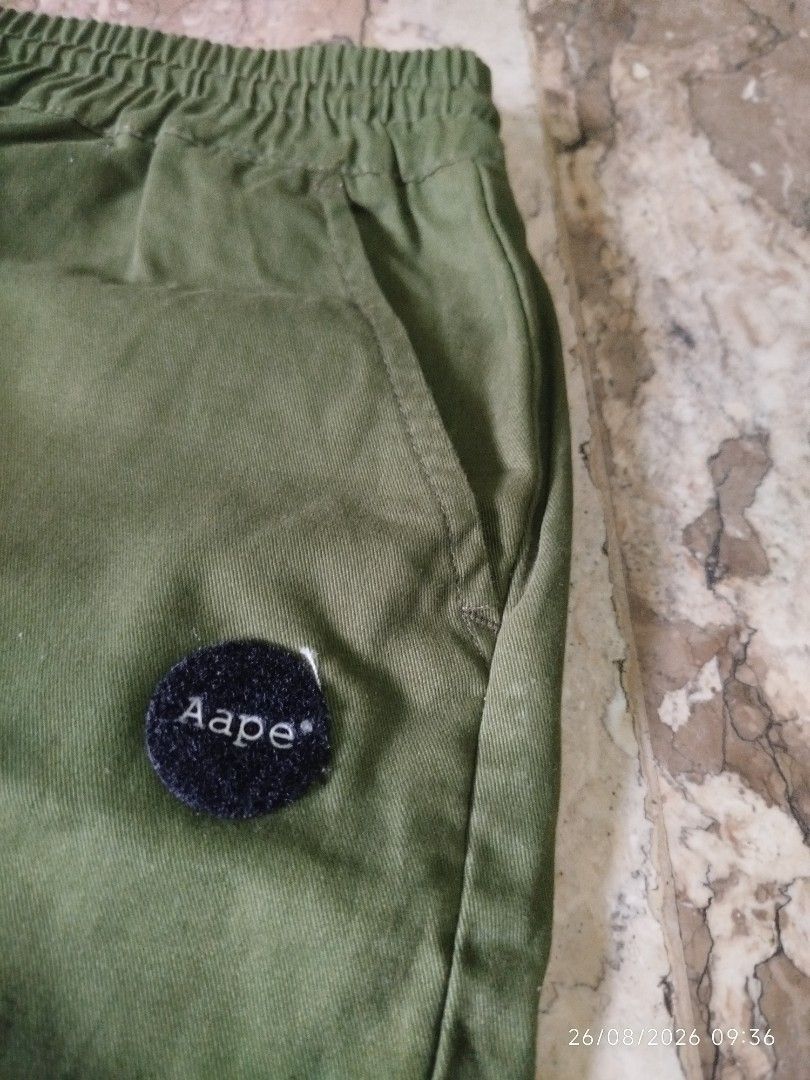 AAPE BY A BATHING APE Cargo Pants Green (Category: Jeans) located in Manila. Submitted by mr.connection (Listing ID 1457726519, Image 3). Description: - Brand: AAPE BY A BATHING APE - Color: Green - Features: Iconic ape head logo on back pocket, text graphic on side - Waist: Elastic waistband with drawstring - Ankles: Cuffed - Style: Great for casual wear.