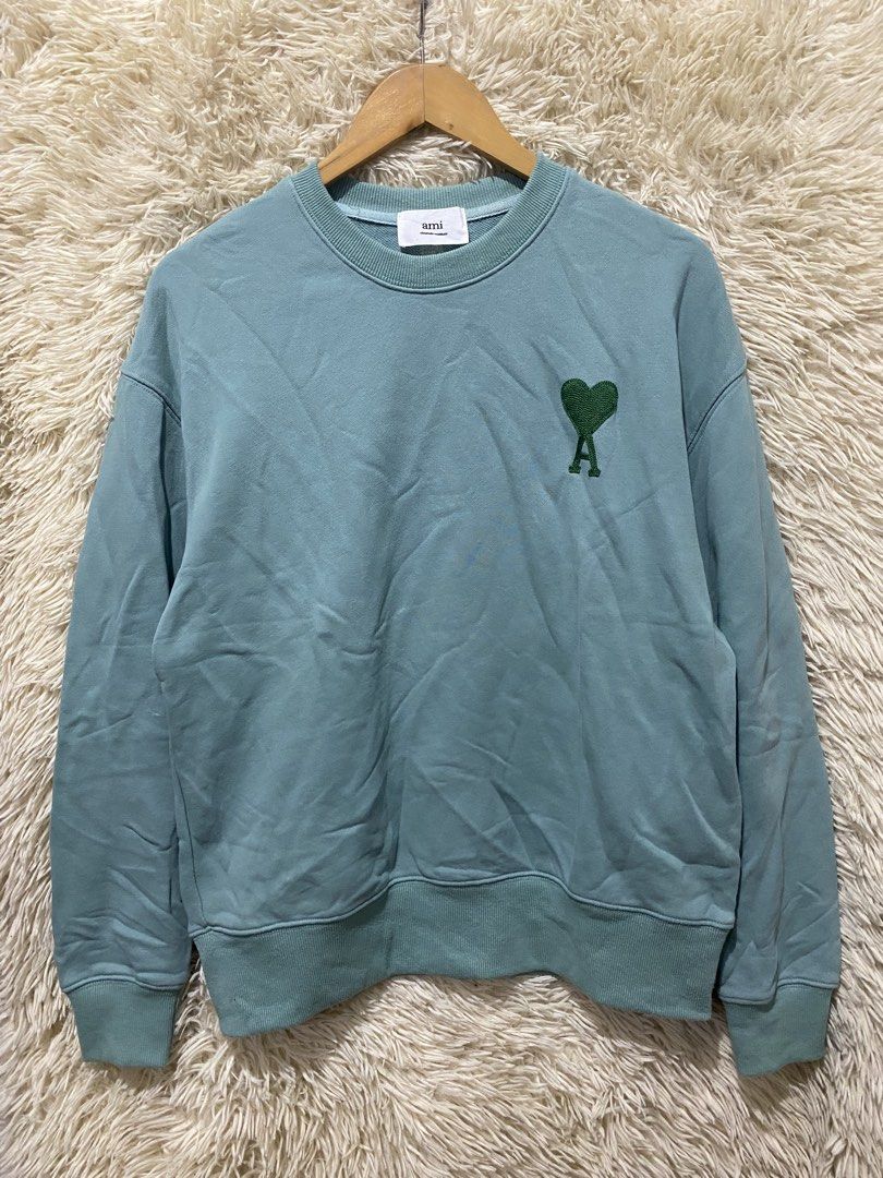AMI Paris Ami de Coeur Sweatshirt Teal (Category: Coats, Jackets and Outerwear) located in Manila. Submitted by switchcity (Listing ID 1457807713, Image 1). Description: - Teal AMI Paris sweatshirt - Signature Ami de Coeur logo embroidered on chest - Classic crewneck design - Ribbed cuffs and hem for a comfortable fit - Made in Portugal - Ideal for everyday casual wear.