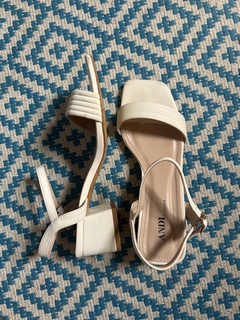 ANDI by Outland White Block Heel Sandals (Category: Flats & Sandals) located in Naga. Submitted by declutteredbyjoanna (Listing ID 1457760978, Image 2). Description: - Brand: ANDI by Outland - Color: White - Style: Block heel sandals - Features: Square toe, strappy upper, buckle ankle strap - Comfort: Comfortable block heel for everyday wear - Versatility: Great for dressing up or down.