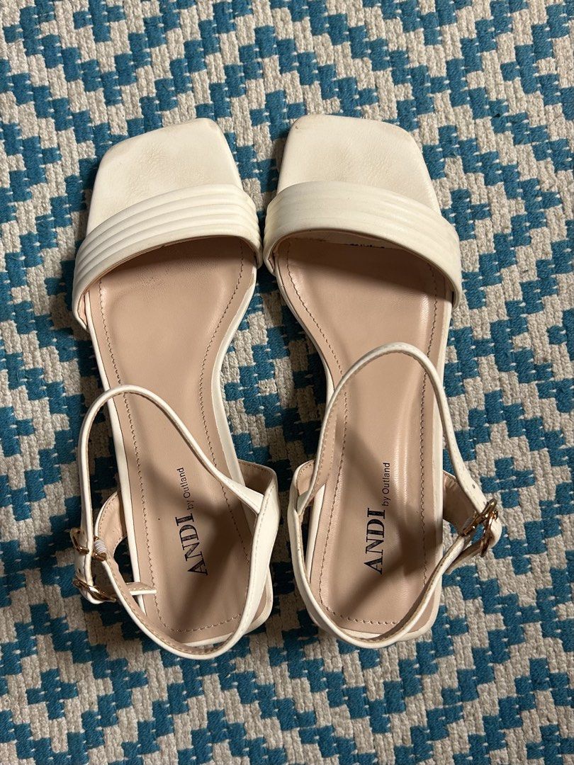 ANDI by Outland White Block Heel Sandals (Category: Flats & Sandals) located in Naga. Submitted by declutteredbyjoanna (Listing ID 1457760978, Image 1). Description: - Brand: ANDI by Outland - Color: White - Style: Block heel sandals - Features: Square toe, strappy upper, buckle ankle strap - Comfort: Comfortable block heel for everyday wear - Versatility: Great for dressing up or down.