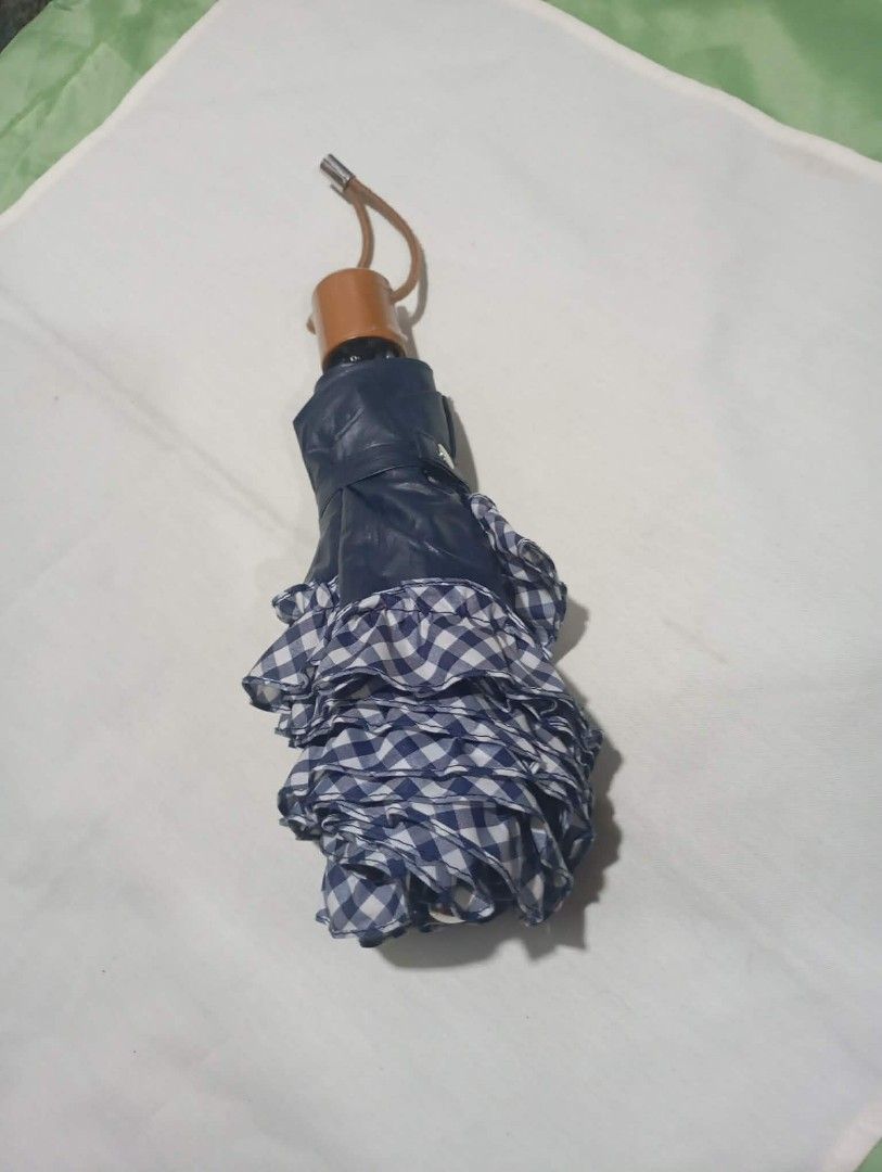 Assorted Umbrellas - Various Brands and Colors (Category: Umbrellas) located in Manila. Submitted by scherielar31543 (Listing ID 1457761303, Image 2). Description: - Foldable umbrellas - Includes: black floral, navy gingham ruffled, black compact, maroon Patrizia Ricci, and red Christian Georges - All umbrellas are functional and ready for use - Perfect for protecting yourself from the rain.