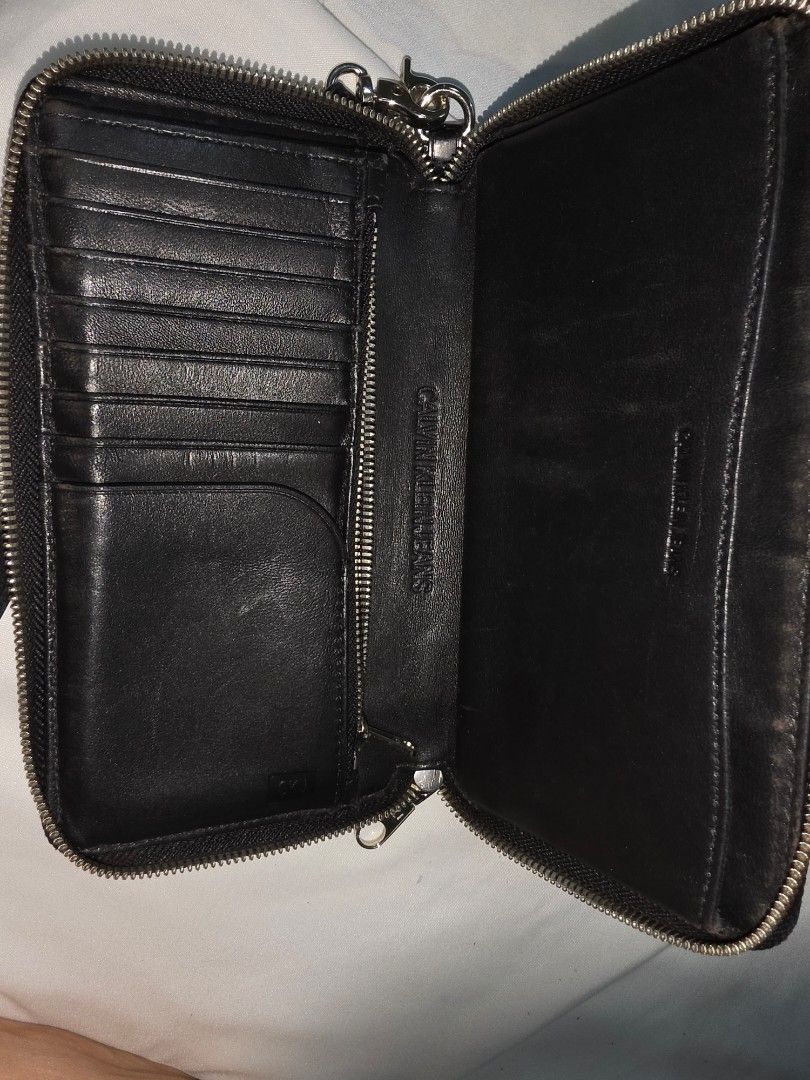 Authentic Calvin Klein wrist wallet (Category: Wallets & Card holders) located in Caloocan City. Submitted by mluck (Listing ID 1457813060, Image 3). Description: issue: sometimes zipper fails to interlock. leather.