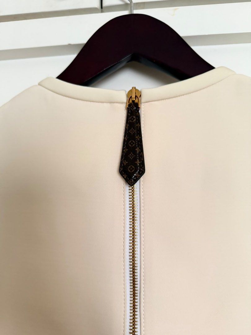 AUTHENTIC LV SS23 Wool/Silk Dress (Category: Dresses) located in Quezon City. Submitted by adnct (Listing ID 1457803560, Image 2). Description: - Louis Vuitton cream short sleeve dress - Decorative gold buttons on shoulders - Back zip closure with monogrammed pull tab - Brand new with original tags attached - Classic wardrobe staple.