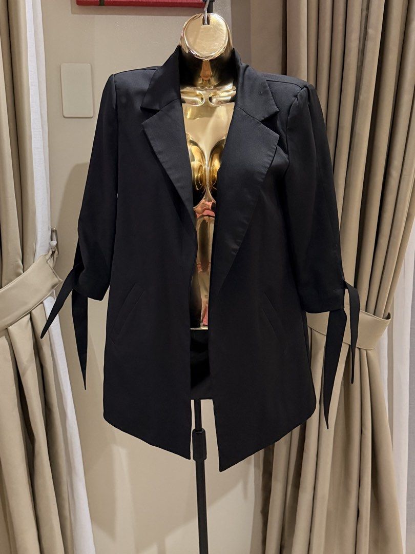 Black Blazer with Tie Sleeve Detail (Category: Coats, Jackets and Outerwear) located in Cavite. Submitted by ohalexa (Listing ID 1457780720, Image 1). Description: - Classic black blazer - Lapel collar - Open front design - Sleeves with tie detail at cuff - Versatile for dressing up or down - Easy to style with various outfits.