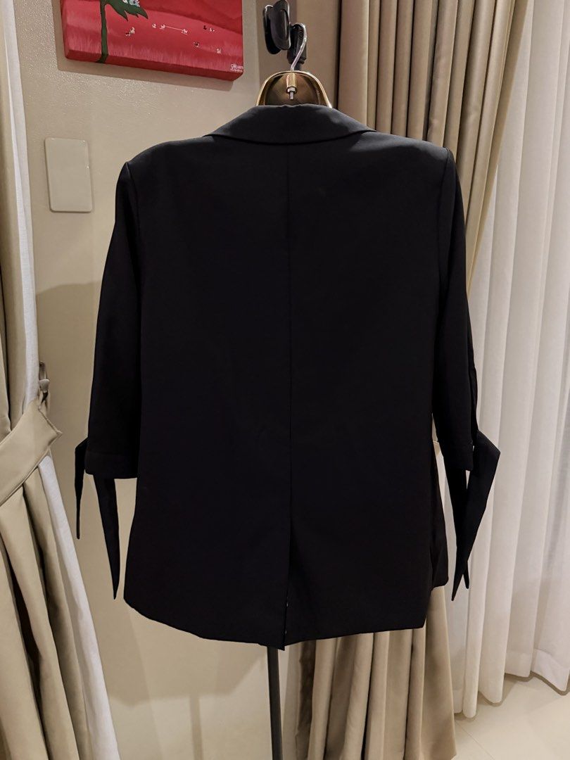 Black Blazer with Tie Sleeve Detail (Category: Coats, Jackets and Outerwear) located in Cavite. Submitted by ohalexa (Listing ID 1457780720, Image 2). Description: - Classic black blazer - Lapel collar - Open front design - Sleeves with tie detail at cuff - Versatile for dressing up or down - Easy to style with various outfits.