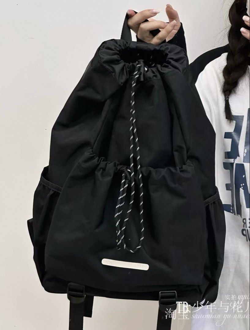 Black Drawstring Backpack with Side Pockets (Category: Backpacks) located in Singapore. Submitted by ccclearingstuff_ (Listing ID 1457720005, Image 1). Description: - Black drawstring backpack - Two side pockets for extra storage - Ideal for everyday use or travel.