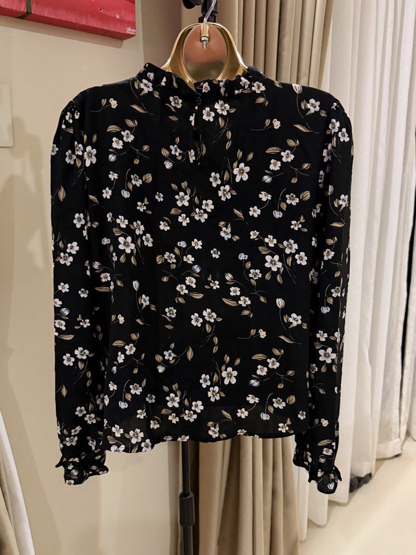 Black Floral Long Sleeve Ruffle Neck Blouse (Category: Blouses) located in Cavite. Submitted by ohalexa (Listing ID 1457780190, Image 2). Description: - Black long sleeve blouse - White and brown floral print - Ruffled neckline - Ruffled cuffs - Button closure at the back - Lightweight fabric - Perfect for layering or standalone wear.
