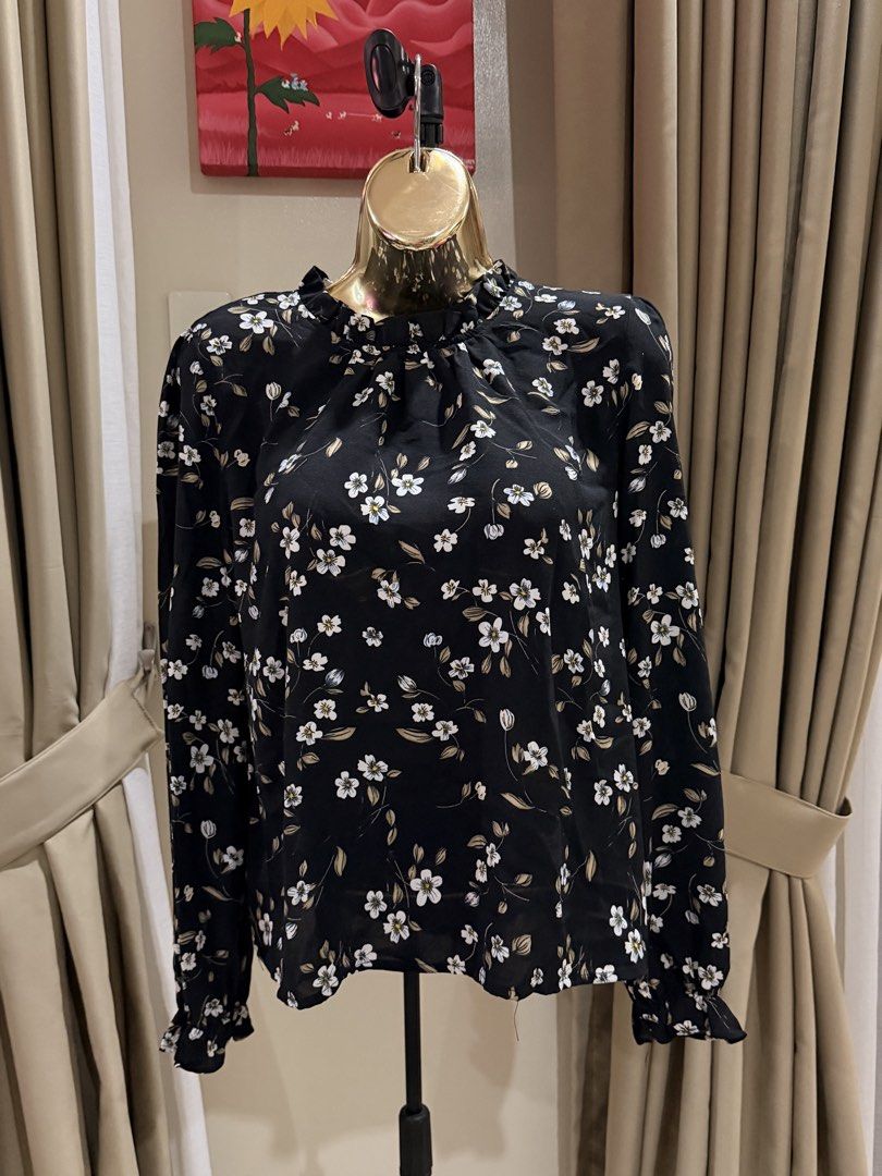 Black Floral Long Sleeve Ruffle Neck Blouse (Category: Blouses) located in Cavite. Submitted by ohalexa (Listing ID 1457780190, Image 1). Description: - Black long sleeve blouse - White and brown floral print - Ruffled neckline - Ruffled cuffs - Button closure at the back - Lightweight fabric - Perfect for layering or standalone wear.