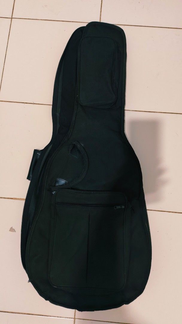 Black Padded Guitar Gig Bag with Pockets (Category: Musical Instruments) located in Bulacan. Submitted by babz30261 (Listing ID 1457740484, Image 1). Description: - Black padded gig bag for guitars - Large front pocket for accessories - Smaller pocket near the top - Secure zipper closure - Adjustable shoulder straps - Convenient carrying handle - Excellent protection for your instrument during transport.
