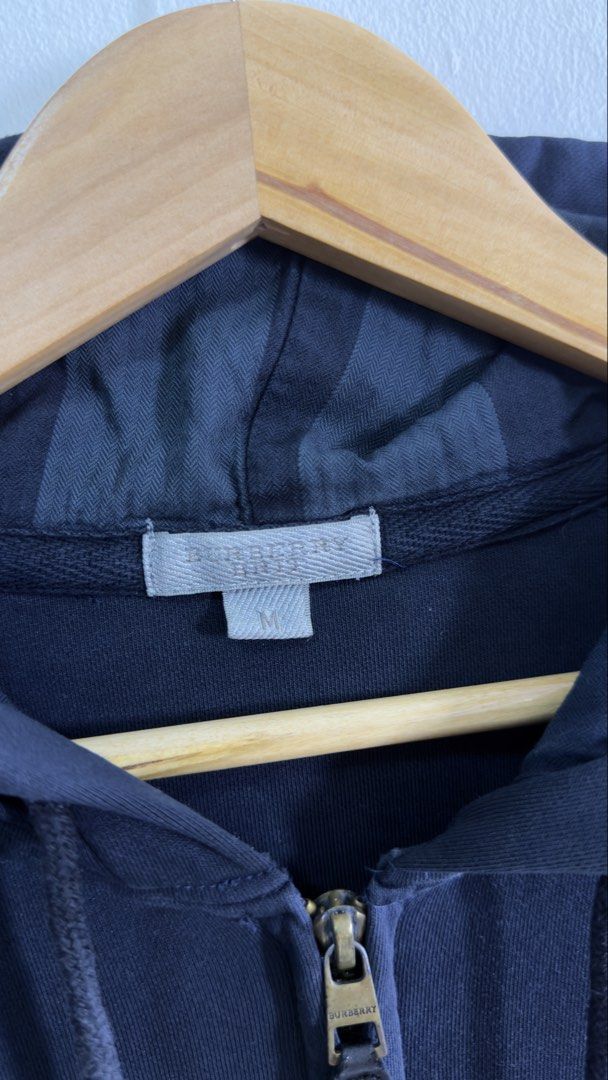 Burberry Black Hoodie with TB Monogram Back (Category: Luxury Apparel) located in Paranaque City. Submitted by preluxeshop_ph (Listing ID 1457831405, Image 3). Description: Burberry Black Hoodie with TB Monogram Back - Size: L - Design: Features the iconic TB monogram on the back - Origin: Made in Italy - Material: 100% Cotton with 5% Elastane for a comfortable fit - Style: Ideal for casual wear and everyday styling - Condition: Please refer to t