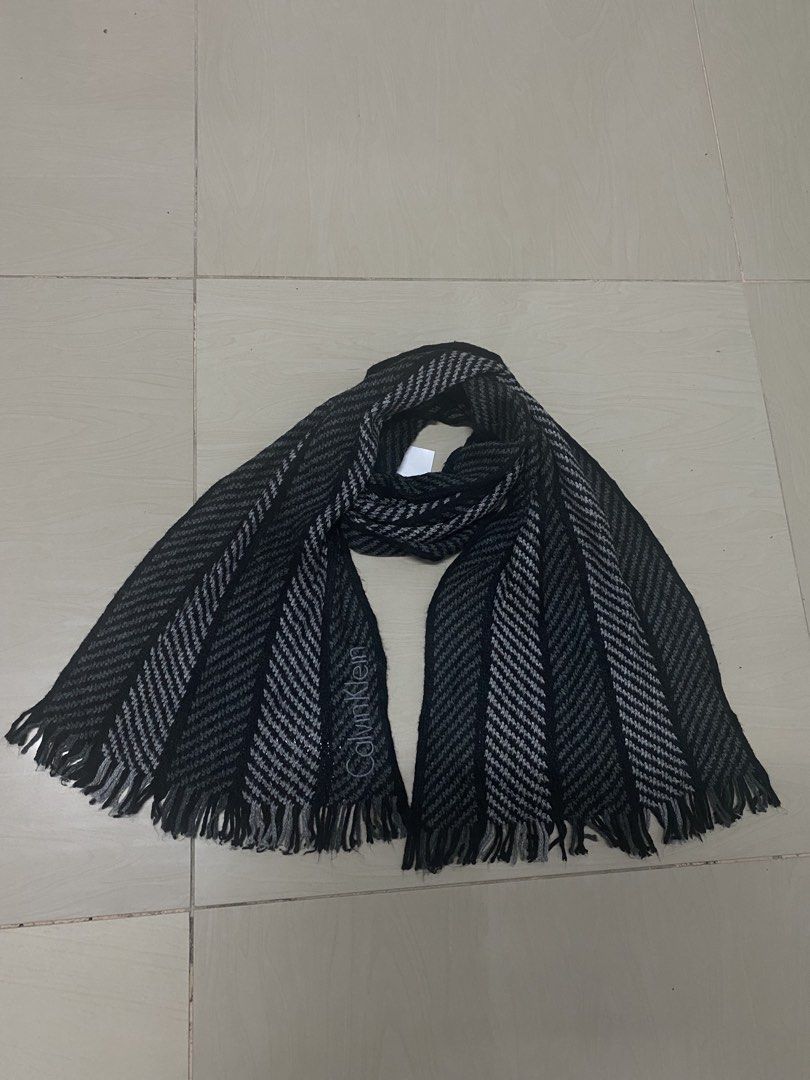 Calvin Klein Black & Grey Striped Scarf (Category: Scarves) located in Manila. Submitted by peculiarplace (Listing ID 1457772791, Image 1). Description: - Brand: Calvin Klein - Pattern: Black and grey herringbone - Material: 100% Acrylic - Features: Fringed edges - Benefit: Great for keeping warm.