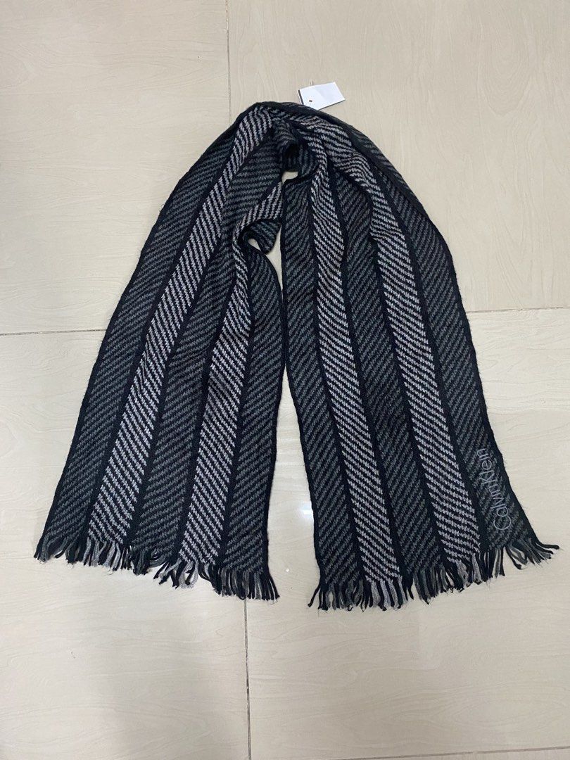 Calvin Klein Black & Grey Striped Scarf (Category: Scarves) located in Manila. Submitted by peculiarplace (Listing ID 1457772791, Image 2). Description: - Brand: Calvin Klein - Pattern: Black and grey herringbone - Material: 100% Acrylic - Features: Fringed edges - Benefit: Great for keeping warm.