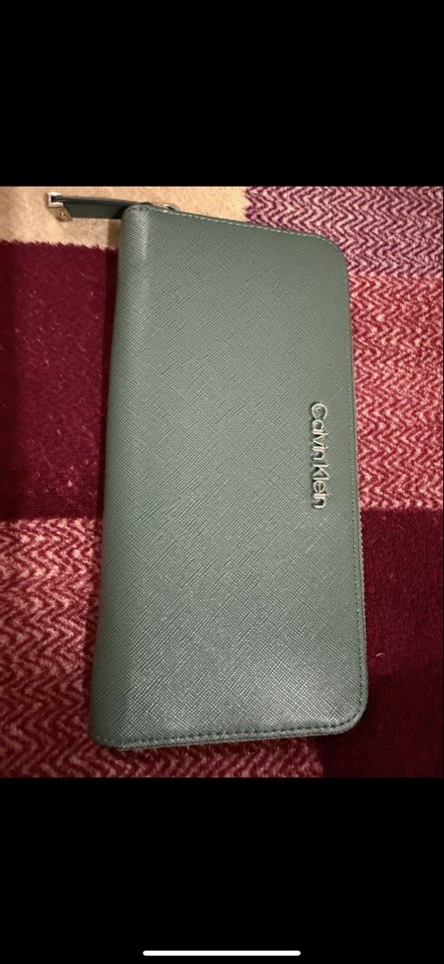 Calvin Klein Wallet (Category: Wallets & Card holders) located in Manila. Submitted by pickstuff (Listing ID 1457731585, Image 1). Description: - Green (Sage) Calvin Klein wallet - Zip-around closure - Ample card slots and compartments - Ideal for organizing essentials .