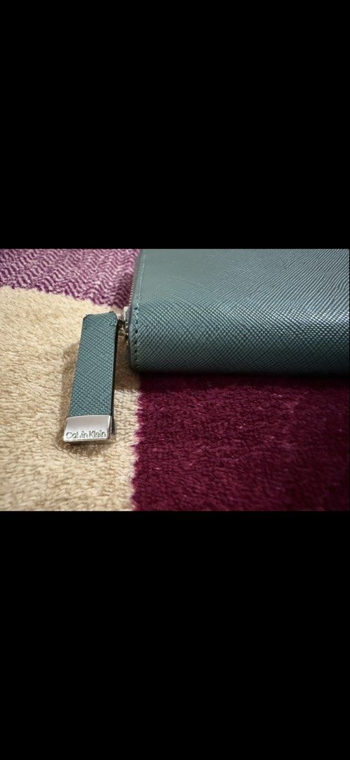 Calvin Klein Wallet (Category: Wallets & Card holders) located in Manila. Submitted by pickstuff (Listing ID 1457731585, Image 2). Description: - Green (Sage) Calvin Klein wallet - Zip-around closure - Ample card slots and compartments - Ideal for organizing essentials .