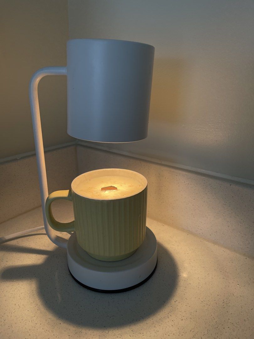 Candle Warmer Lamp with Mug and Candle (Category: Other Home Decor) located in Quezon City. Submitted by Mike_0 (Listing ID 1457749691, Image 2). Description: Selling our Candle light with warmer Oat scented 1200 only for the set For the breakdown Candle warmer - 1k Scented candle - 500 Bulb - 200 Location - Cypress Village Cainta near Junction / Proj 4 Cubao QC.