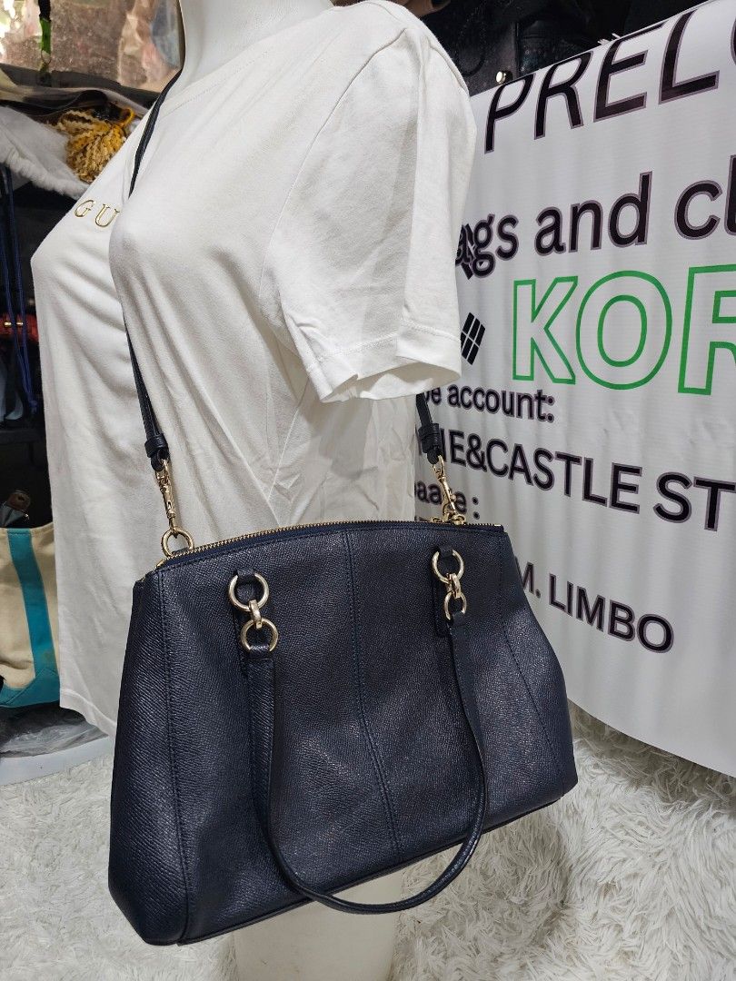 Coach Pebbled Leather Satchel Navy Blue (Category: Luxury Bags & Wallets) located in Cavite. Submitted by liveriver_514fd1 (Listing ID 1457748631, Image 2). Description: - Brand: Coach - Color: Navy Blue - Material: Pebbled Leather - Hardware: Gold-tone - Straps: Top handles and detachable crossbody strap - Closure: Zipper - Features: Spacious interior, ideal for everyday use.