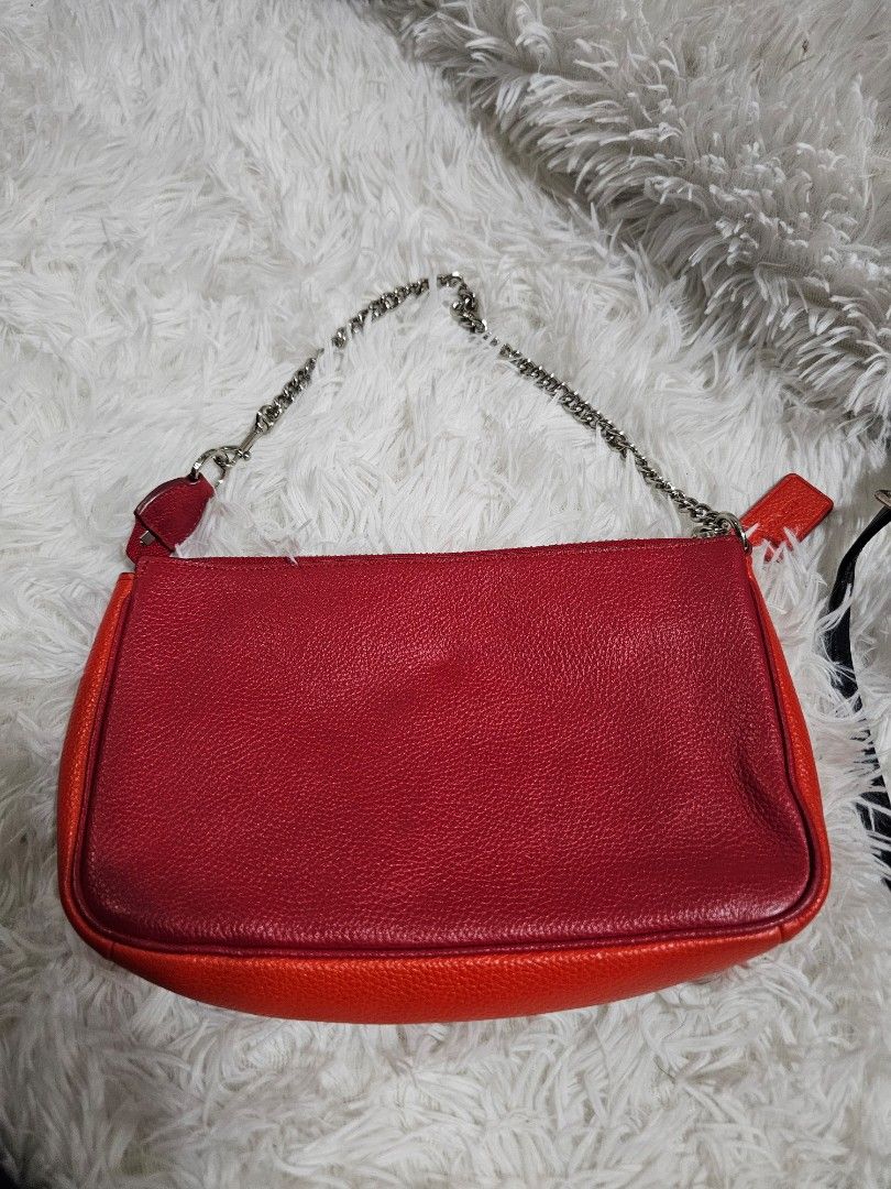 Coach Red Leather Crossbody Bag with Silver Chain (Category: Luxury Bags & Wallets) located in Cavite. Submitted by liveriver_514fd1 (Listing ID 1457749993, Image 2). Description: - Authentic Coach red leather crossbody bag - Features a convenient front zippered pocket - Stylish silver chain strap - Includes a small red Coach tag - Ideal for carrying your daily essentials - Chic and versatile design.