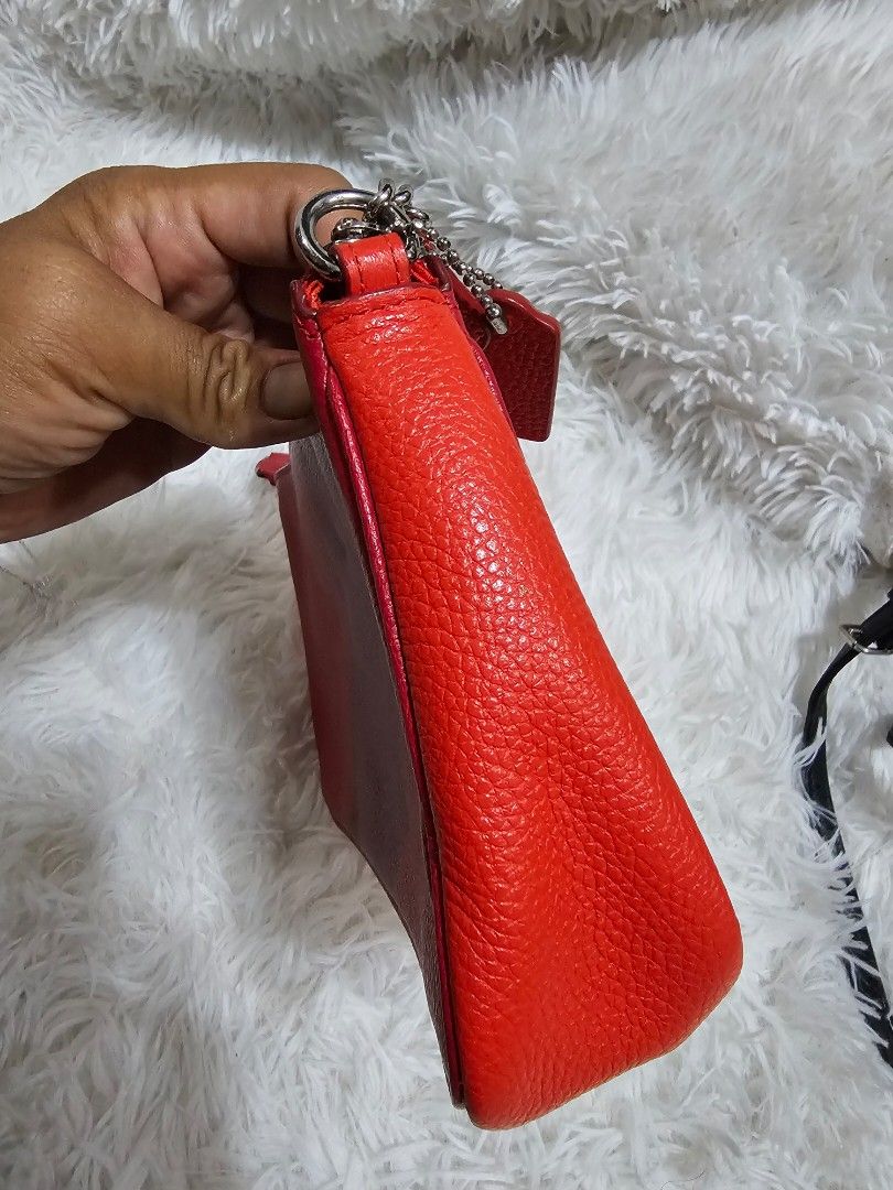 Coach Red Leather Crossbody Bag with Silver Chain (Category: Luxury Bags & Wallets) located in Cavite. Submitted by liveriver_514fd1 (Listing ID 1457749993, Image 3). Description: - Authentic Coach red leather crossbody bag - Features a convenient front zippered pocket - Stylish silver chain strap - Includes a small red Coach tag - Ideal for carrying your daily essentials - Chic and versatile design.