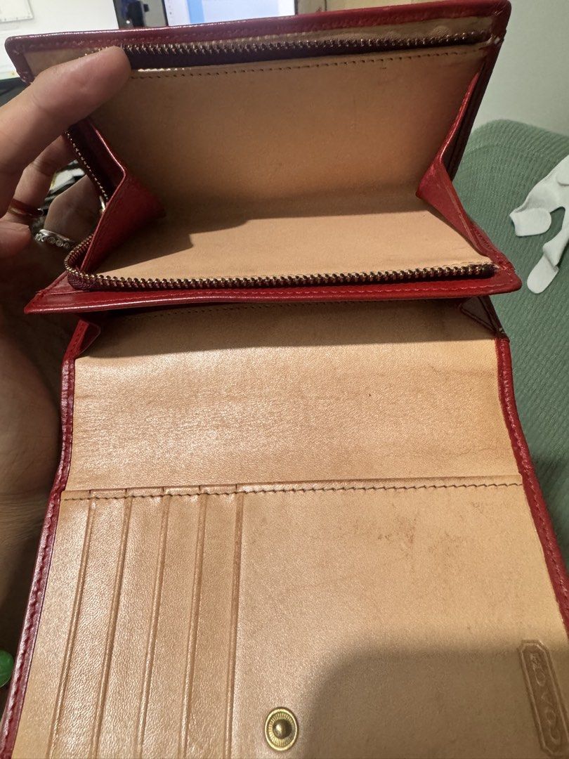 Coach Red Monogram Leather Bifold Wallet (Category: Luxury Bags & Wallets) located in Pasay City. Submitted by mydeer08 (Listing ID 1457879101, Image 3). Description: - Authentic Red Coach wallet - Signature monogram pattern - Made in Spain - Genuine leather interior - Features card slots - Includes a zip compartment - Interior shows some signs of wear - Plenty of life remaining.