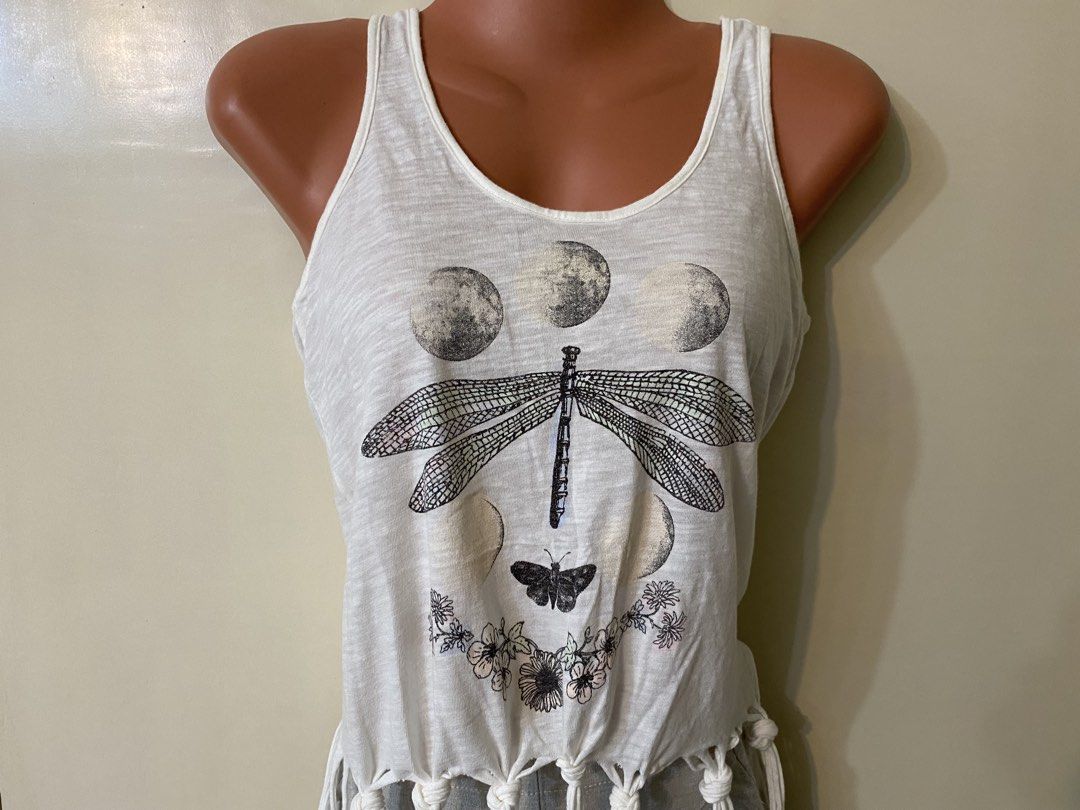 Coachella Fringe Tank Top (Category: Sleeveless) located in Taguig. Submitted by wena11 (Listing ID 1457802570, Image 3). Description: Bethany Mota White Dragonfly Moon Fringe Tank Top XS - Brand: Bethany Mota by Aeropostale - Color: cream/off White - Size: XS - Design: Dragonfly and moon graphic - Detail: Fringe at the bottom hem - Material: 100% Cotton Used once only You can tie or untie the fringes depending on the look you want to go for. ***