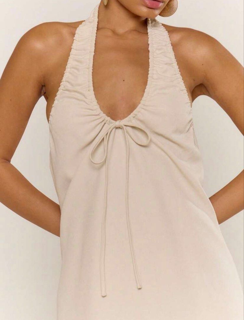 Cream Halter Neck Ruched Tie Front Mini Dress (Category: Dresses) located in Manila. Submitted by maedeguzmann (Listing ID 1457821665, Image 1). Description: - Cream mini dress - Halter neckline - Ruched bust detail - Tie front - Sleeveless - Versatile for day or night wear - Pairs well with sandals or heels.