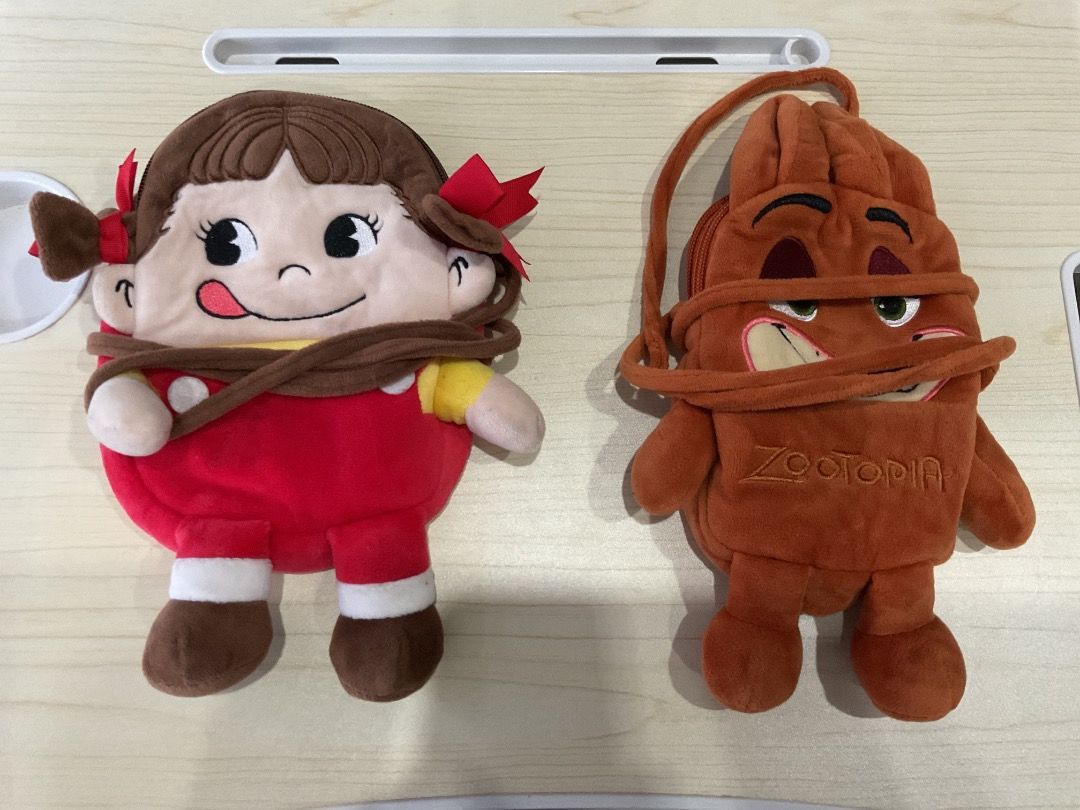 Cute Plush Coin Purses - Character Design (Category: Plushies & Soft Toys) located in Manila. Submitted by rylansstuff (Listing ID 1457799181, Image 1). Description: - Two adorable plush coin purses available. - Design 1: Character with red overalls and pigtails. - Design 2: Brown character with 'Zootopia' embroidery. - Features a secure zipper closure. - Includes a convenient string strap for easy carrying. - Ideal for storing coins, keys, earbu