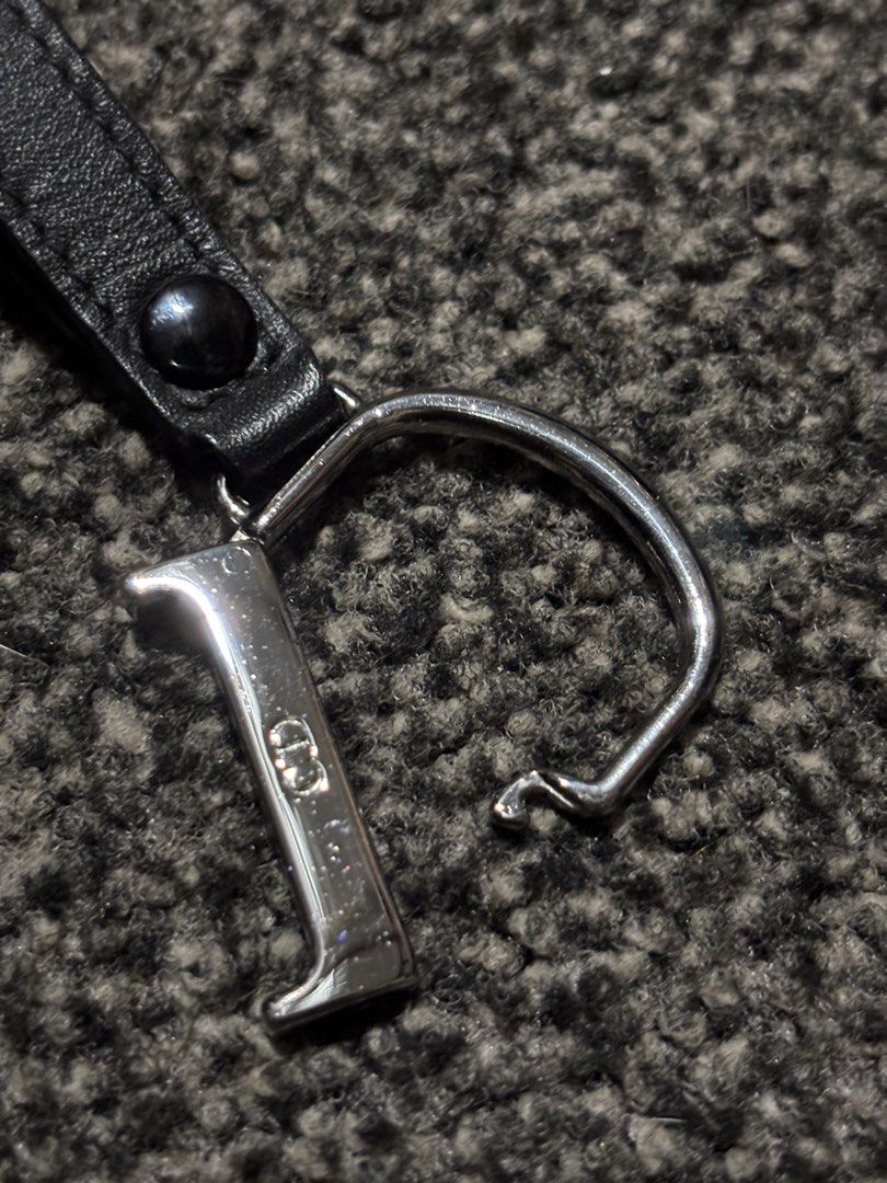 Dior Keychain (Category: Luxury Accessories) located in Bulacan. Submitted by thriftstarph (Listing ID 1457857384, Image 3). Description: PLEASE READ THE DESCRIPTION BELOW ‼️ Dior Keychain Leather Engraved Dior Logo From: Japan No Issue.