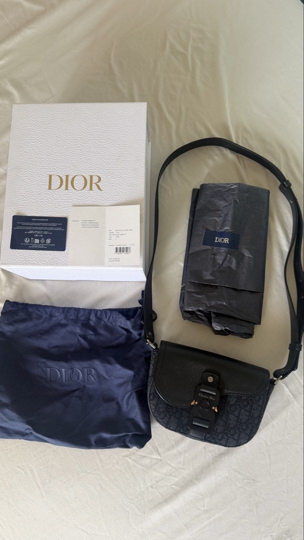 Dior Mini Saddle Messenger Bag with Flap (Category: Luxury Bags & Wallets) located in Quezon City. Submitted by cristealyanna (Listing ID 1457748967, Image 1). Description: Inclusions: Original Dior box, dust bag, authenticity card, and original purchase store tag (Retail Price: ₱125,000) >Navy Blue >Oblique monogram canvas leather trim >Adjustable shoulder strap >Foldover top >Buckle fastening >Internal slip pocket >Silver-tone hardware Conditio