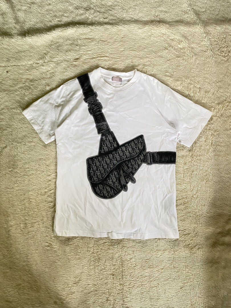 Dior White Saddle Bag Logo T-Shirt (Category: Luxury Apparel) located in Manila. Submitted by 2ndmemoir (Listing ID 1457769370, Image 1). Description: Dior White Saddle Bag Logo T-Shirt No issue Excellent condition 9.8 colorate Good as new 19.5 inches width 26.5 inches length.