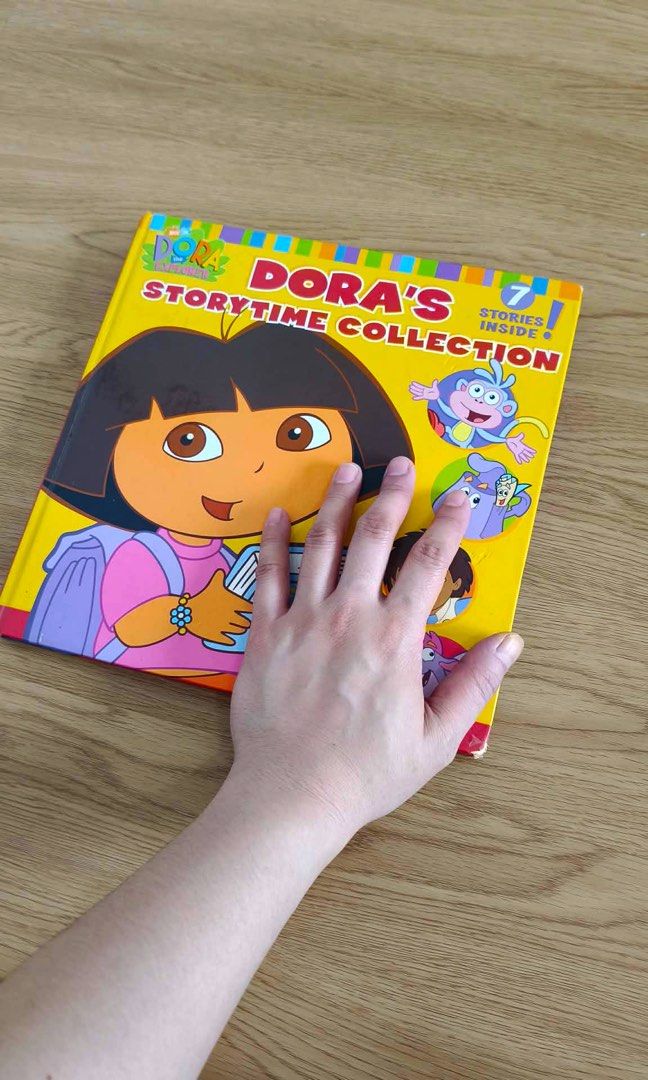 Dora's Story Time Collection Book - 7 Stories Inside (Category: Children's Books) located in Makati City. Submitted by adventuresofjujucloset (Listing ID 1457792022, Image 2). Description: - Collection of 7 Dora the Explorer stories - Features Spanish words, great for bilingual learning - Fun and engaging illustrations on every page - Ideal for young readers who love Dora - Perfect for bedtime stories.