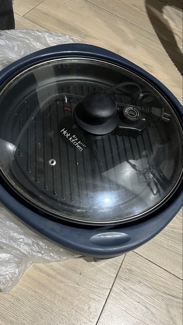 Dowell Hot Kitchen Electric Grill (Category: Cookware & Accessories) located in Pasig City. Submitted by tylernchloe (Listing ID 1457721885, Image 1). Description: - 220v 1300w - With glass lid - Adjustable temperature control - Raised grilling ridges for nice grill marks - Approx 35cm diameter - See pic for minor scratch on plastic - Easy to clean.