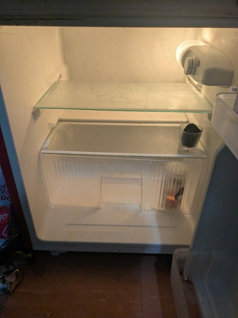 Fujidenzo Red Mini Refrigerator (Category: Refrigerators and Freezers) located in San Juan City. Submitted by dashofdashii (Listing ID 1457895270, Image 3). Description: - Red Fujidenzo mini fridge - Top freezer compartment - Main refrigerator compartment below - Minor wear on the door seal - Still fully functional - Ideal for dorm rooms or small living spaces - bought in 2019.