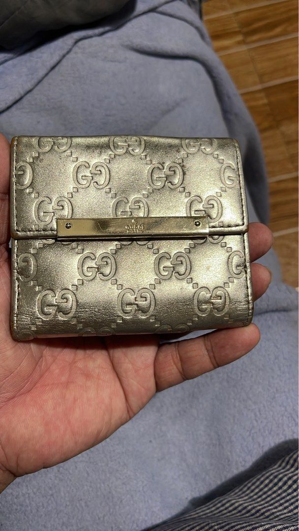 Gucci GG Monogram Wallet Silver Metallic Leather (Category: Luxury Bags & Wallets) located in Mandaluyong City. Submitted by mark2pac (Listing ID 1457836879, Image 2). Description: - Authentic Gucci bi-fold wallet - Silver metallic leather with signature GG monogram - Snap closure - Multiple interior card slots and compartments - Made in Italy - Shows some signs of wear on the interior lining - Functional and stylish piece.