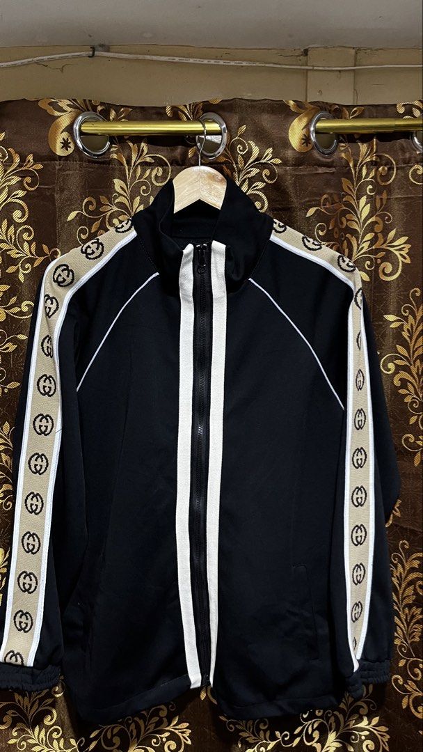 Gucci Track Jacket Black GG Monogram (Off Only) (Category: Luxury Apparel) located in Tacloban City. Submitted by rxluminoque (Listing ID 1457832766, Image 1). Description: - Iconic Gucci GG monogram stripe on sleeves - Classic black track jacket - White piping details on front and back - Full zip closure - Versatile for casual wear or athleisure - Sharp and stylish look.