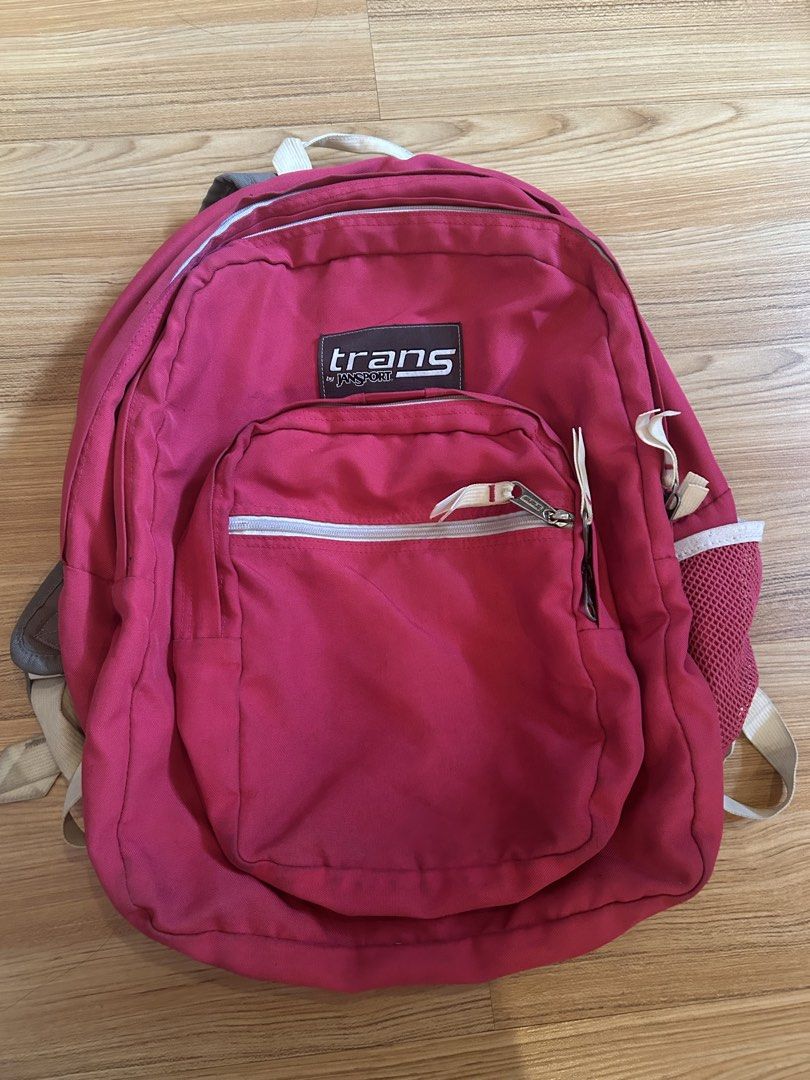 Jansport Backpacks - (Category: Backpacks) located in Quezon City. Submitted by bmswardrobe (Listing ID 1457759848, Image 2). Description: - Three Jansport backpacks available. (Pink -450; Gray w Flower- 400; Checkered - 350) - Bright pink backpack with a front zip pocket. - Dark grey backpack featuring a floral bottom panel and a mesh side pocket. - Dark plaid patterned backpack. - All backpacks have adjustable straps and multiple compartments. 