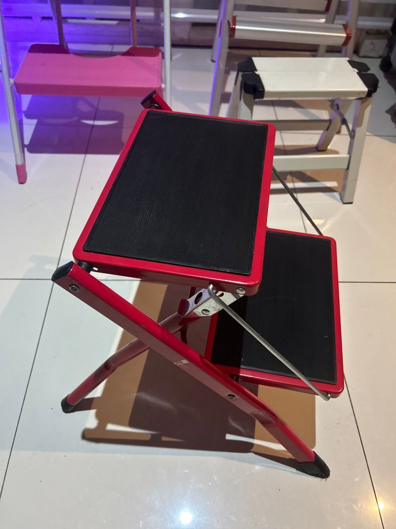 JAPAN Red 2-Step Folding Step Stool 16” Ladder (Category: Chairs) located in Las Pinas. Submitted by rusc.rusc (Listing ID 1457861799, Image 2). Description: JAPAN Red 2-Step Folding Step Stool 16” Ladder VG condition Las Pinas near City Hall - Sturdy red 2-step folding step stool - Black anti-slip treads for safety - Folds flat for convenient storage - Ideal for reaching high shelves - Can also be used as a small seat - Durable metal constructio