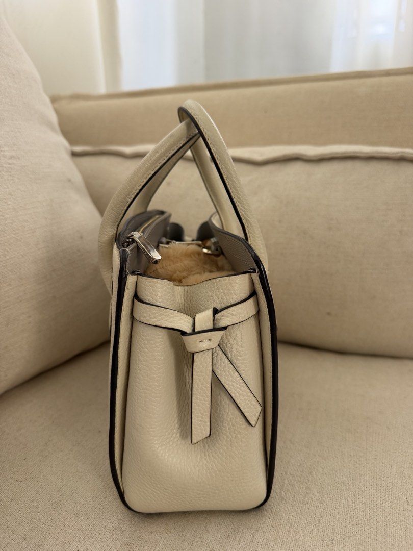 Kate Spade Knott Mini Satchel Bag (Category: Luxury Bags & Wallets) located in Bulacan. Submitted by lauraandre29730 (Listing ID 1457719475, Image 3). Description: - Authentic Kate Spade New York white leather top handle bag - Structured and stylish design - Secure zip closure - Unique side knot detailing - Features a soft, fuzzy interior lining - Versatile for everyday use or special events.