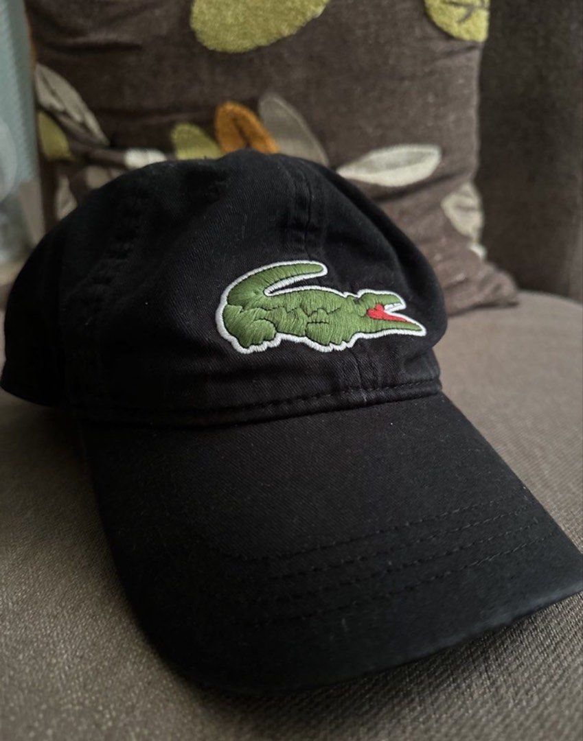 Lacoste Cap (Category: Caps & Hats) located in Subic. Submitted by declutterbyshit (Listing ID 1457888509, Image 1). Description: - Classic black Lacoste cap - Features iconic green crocodile logo embroidered on the front - Brand name repeated on internal bands - Adjustable strap at the back for a comfortable fit - Versatile accessory for casual outfits.