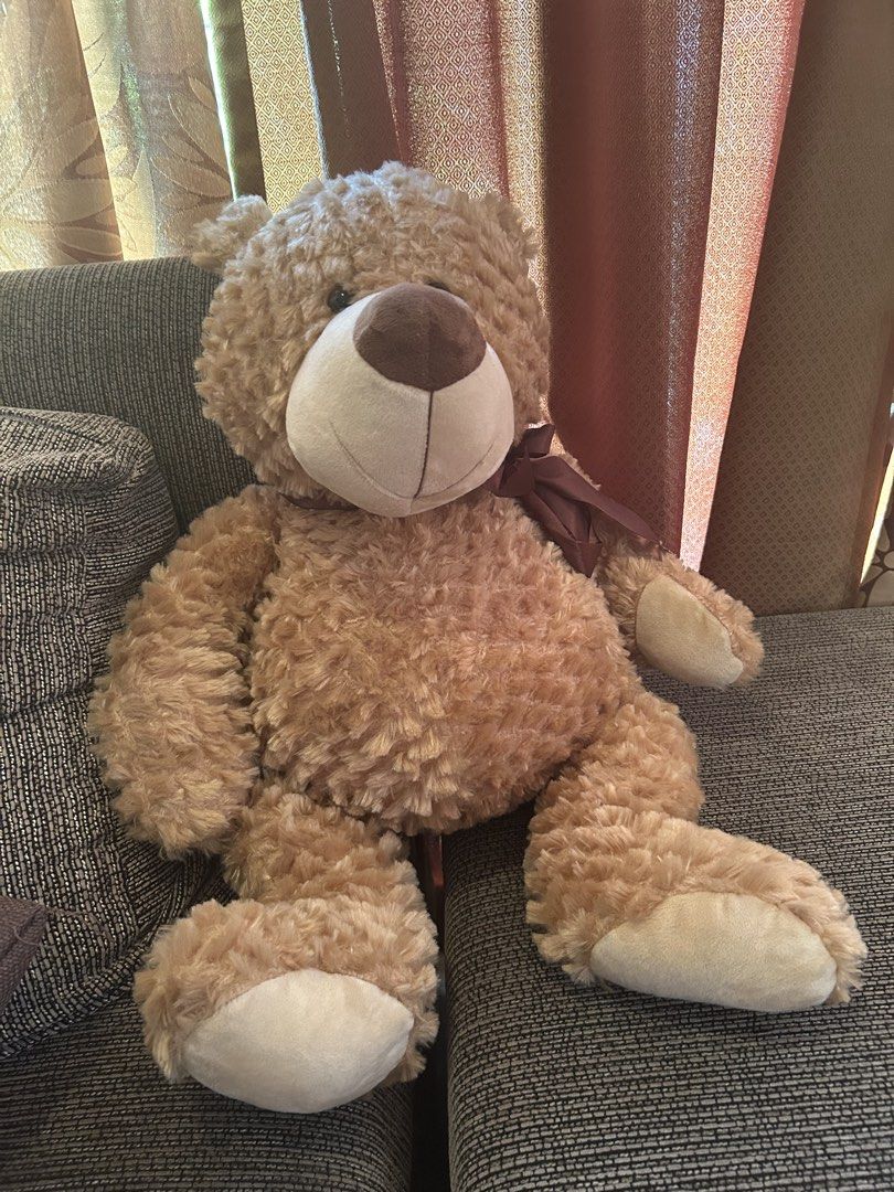 Large Brown Teddy Bear Plush Toy (Category: Plushies & Soft Toys) located in Quezon City. Submitted by bmswardrobe (Listing ID 1457761214, Image 1). Description: - Big and fluffy teddy bear - Super soft and cuddly - Features a cute ribbon around its neck - Minor tear on the back, requires a simple stitch - Ideal for hugs or as a room decoration.
