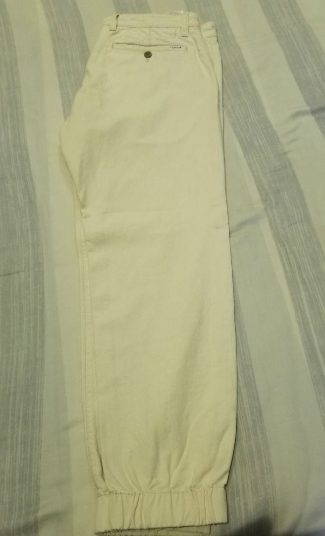 Levi's Cream Chino Jogger Pants (Category: Joggers) located in Quezon City. Submitted by eman438600 (Listing ID 1457840581, Image 2). Description: - Brand: Levi's - Color: Cream - Style: Chino Jogger Pants - Features: Elasticated cuffs, button and zip front closure, two side pockets, one buttoned back pocket - Occasion: Casual wear - Styling: Easy to pair with any top.