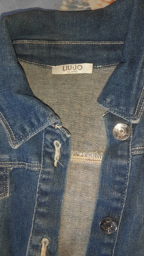 Liu Jo Denim Jacket (Category: Coats, Jackets and Outerwear) located in Bay. Submitted by silverhorse-59c851 (Listing ID 1457753417, Image 2). Description: - Classic blue denim jacket by Liu Jo - Button-up front closure - Two chest pockets - Distressed, frayed cuffs for a stylish look - Ideal for layering and versatile styling.